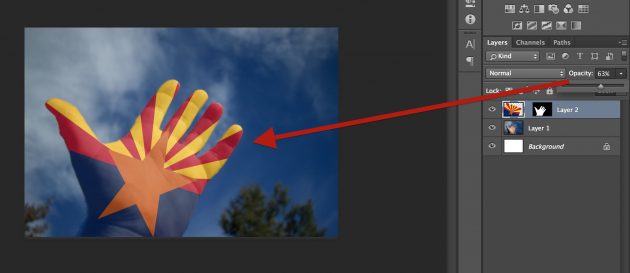 Letting the hand show through by dropping the opacity of the flag layer to 63%