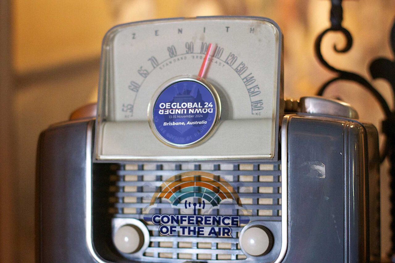 An old radio with OEGlobal logo and conference of the air logo superimposed