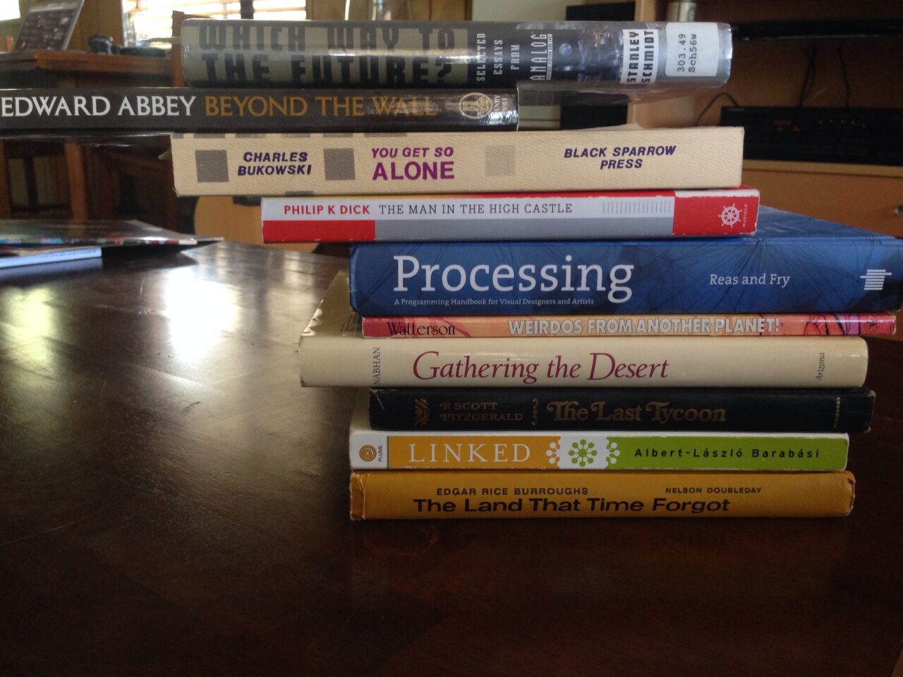 A stack of books with the spines attemtping to tell a story, the one in the middle is a book titled Processing