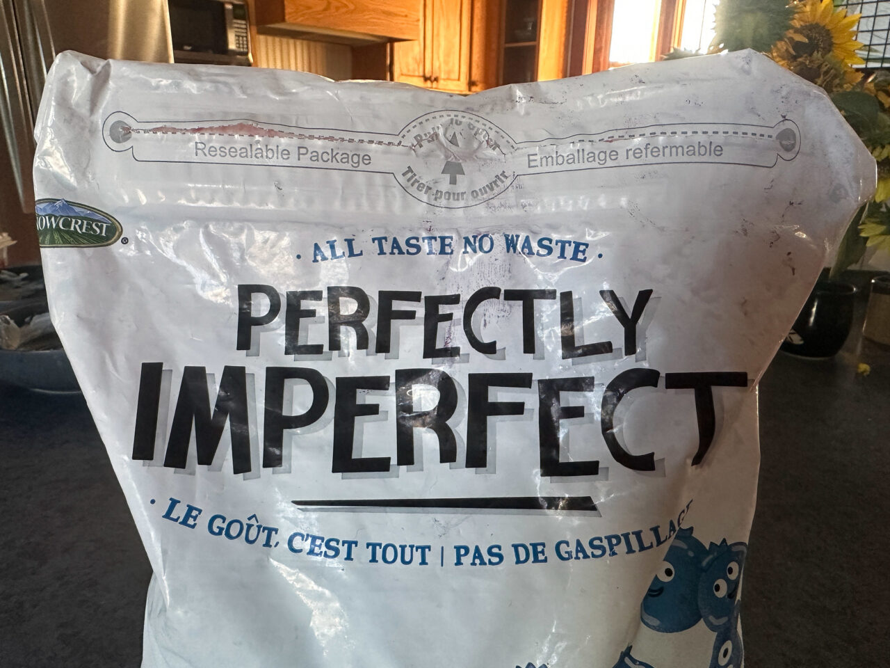 Package of frozen blurberrirs with the brand name Perfectly Imperfect. At the time it reads All taste no waste.