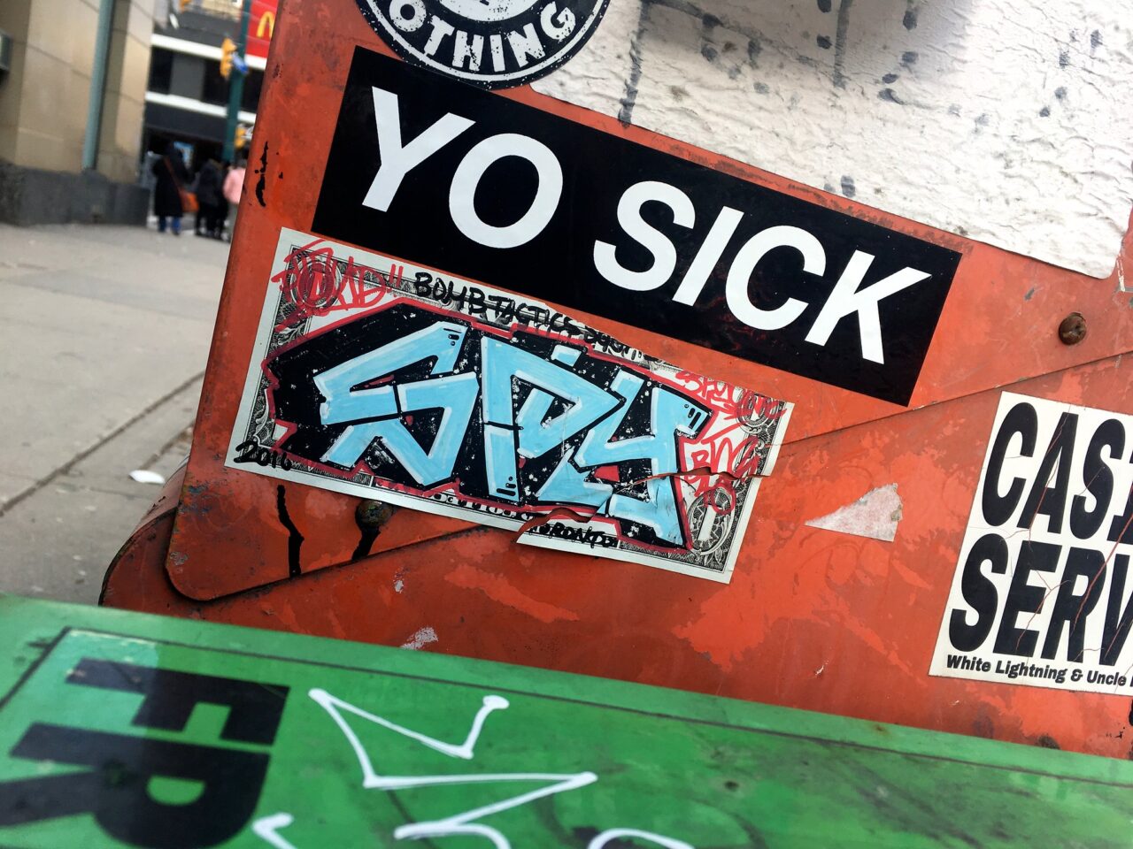 Graffiti sign readin Yo Sock in alley. Cough cough cough.