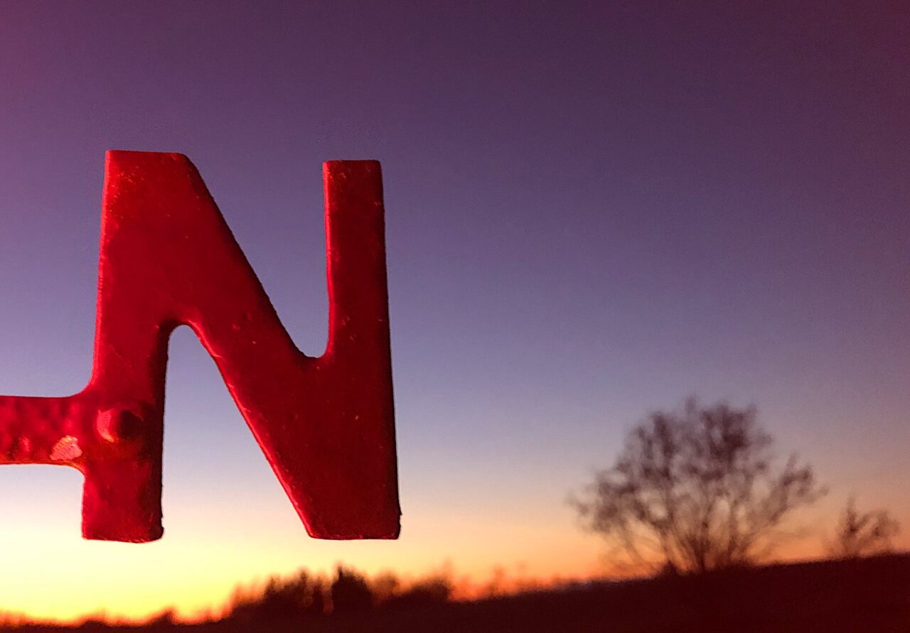 A giant N in front of a sunset.